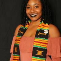 student smiling for a picture at the photo booth